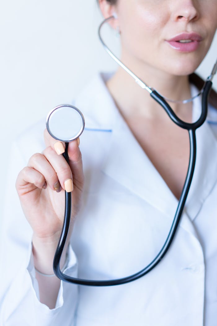 Close-up of a female doctor holding a stethoscope, symbolizing healthcare.